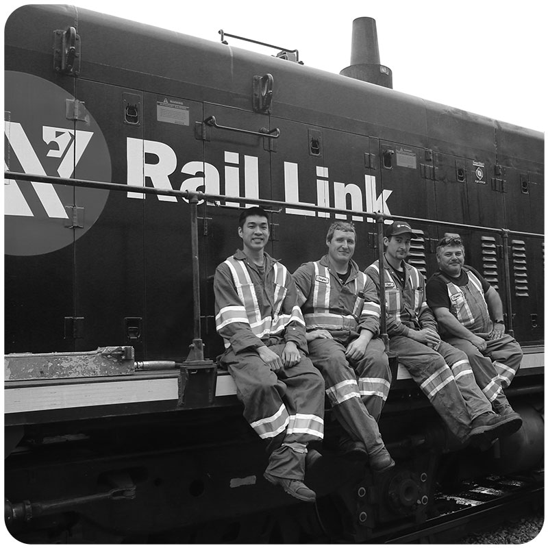 Four workers sitting on a locomotive